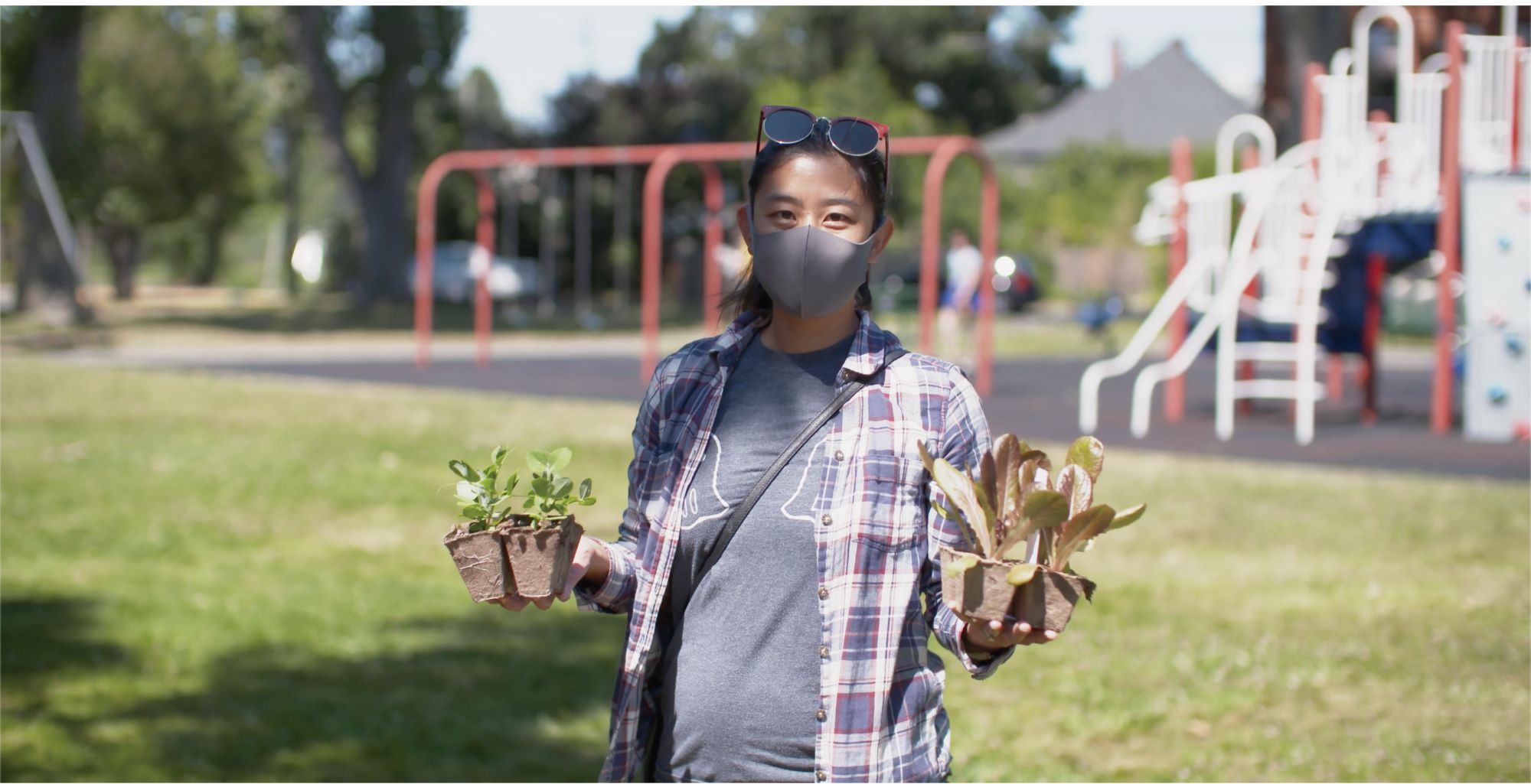 Woman holding plants. The Victoria Community Food Hub was the recipient of a grant from the Rapid Relief Fund.