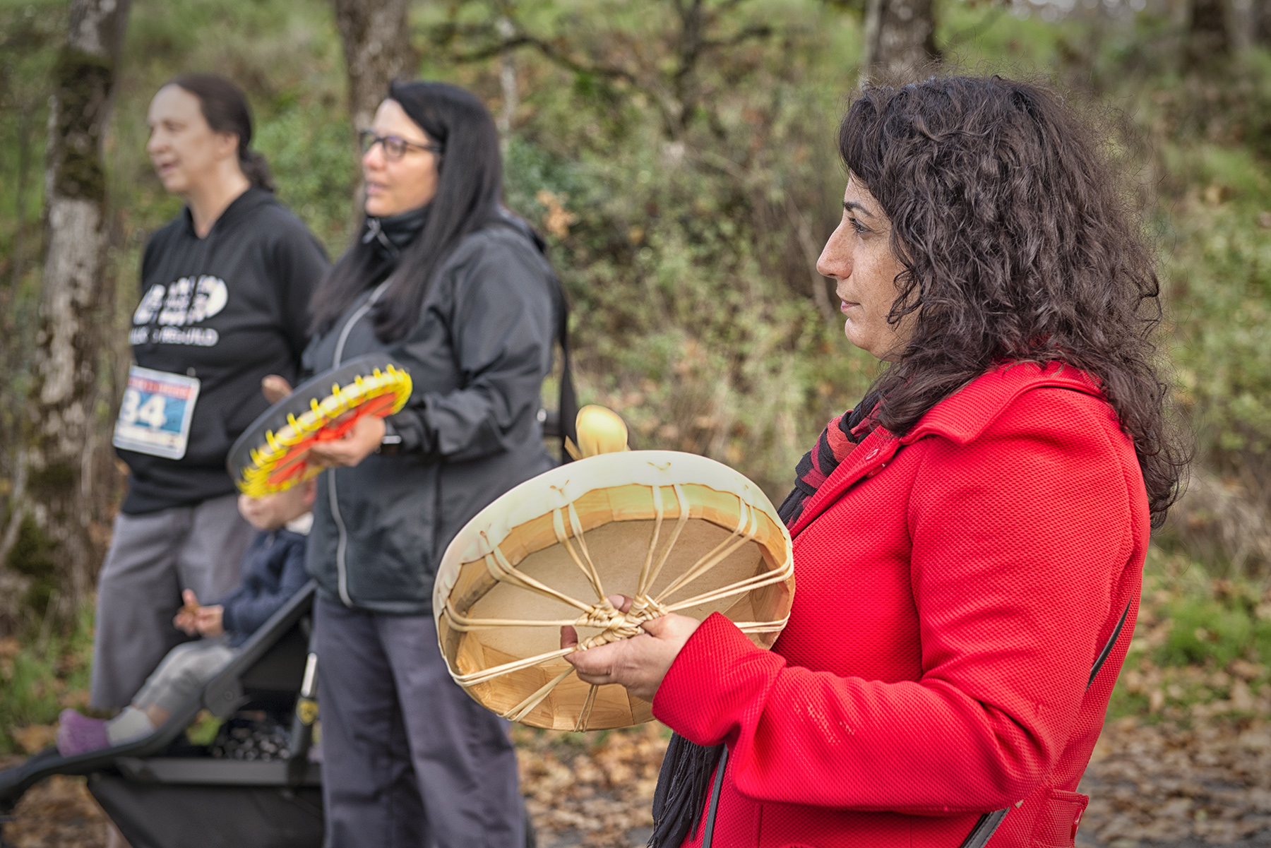 Woman plays Indigenous drum at HeroWork reveal.