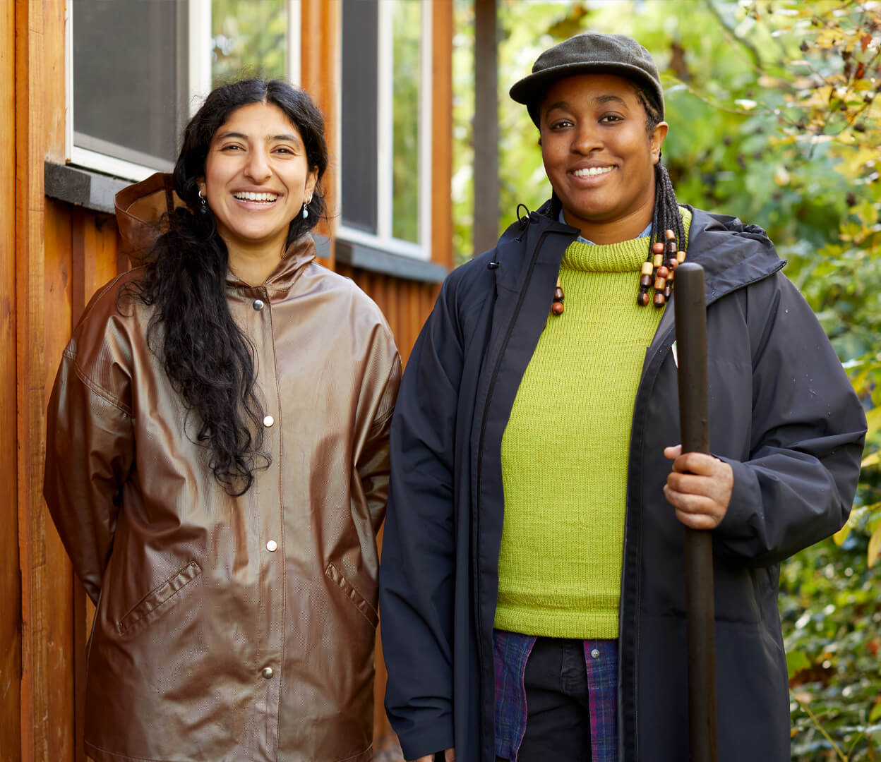Two smiling women stand outside the Compost Education Centre.