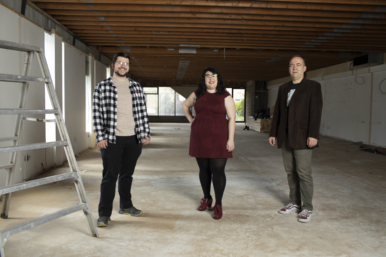 SKAM group stands together in performance space. 