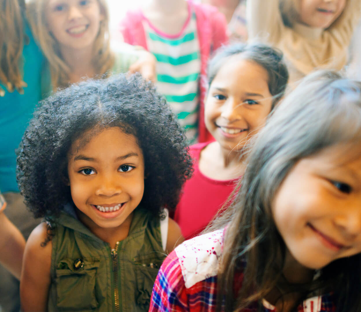 A group of diverse children are having fun together.