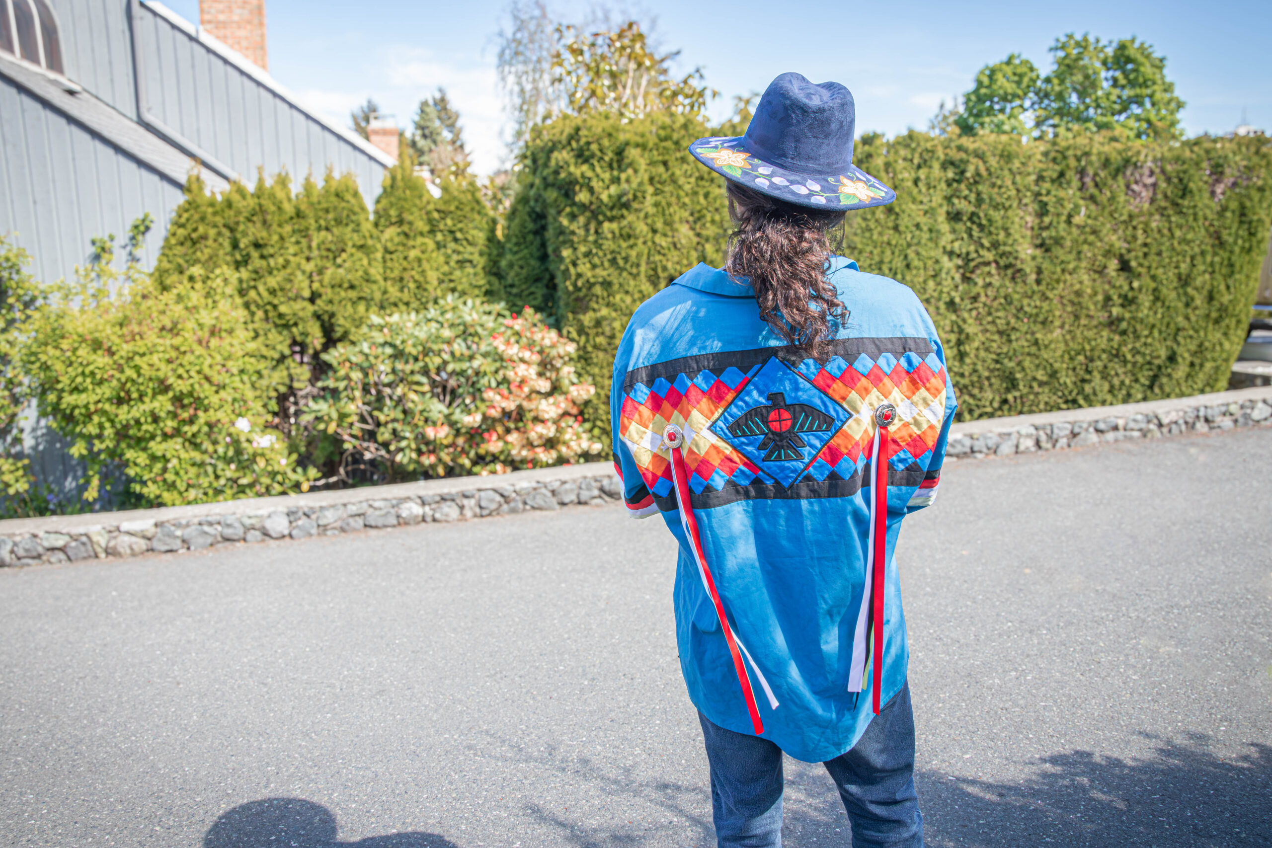 Person wearing Indigenous regalia.