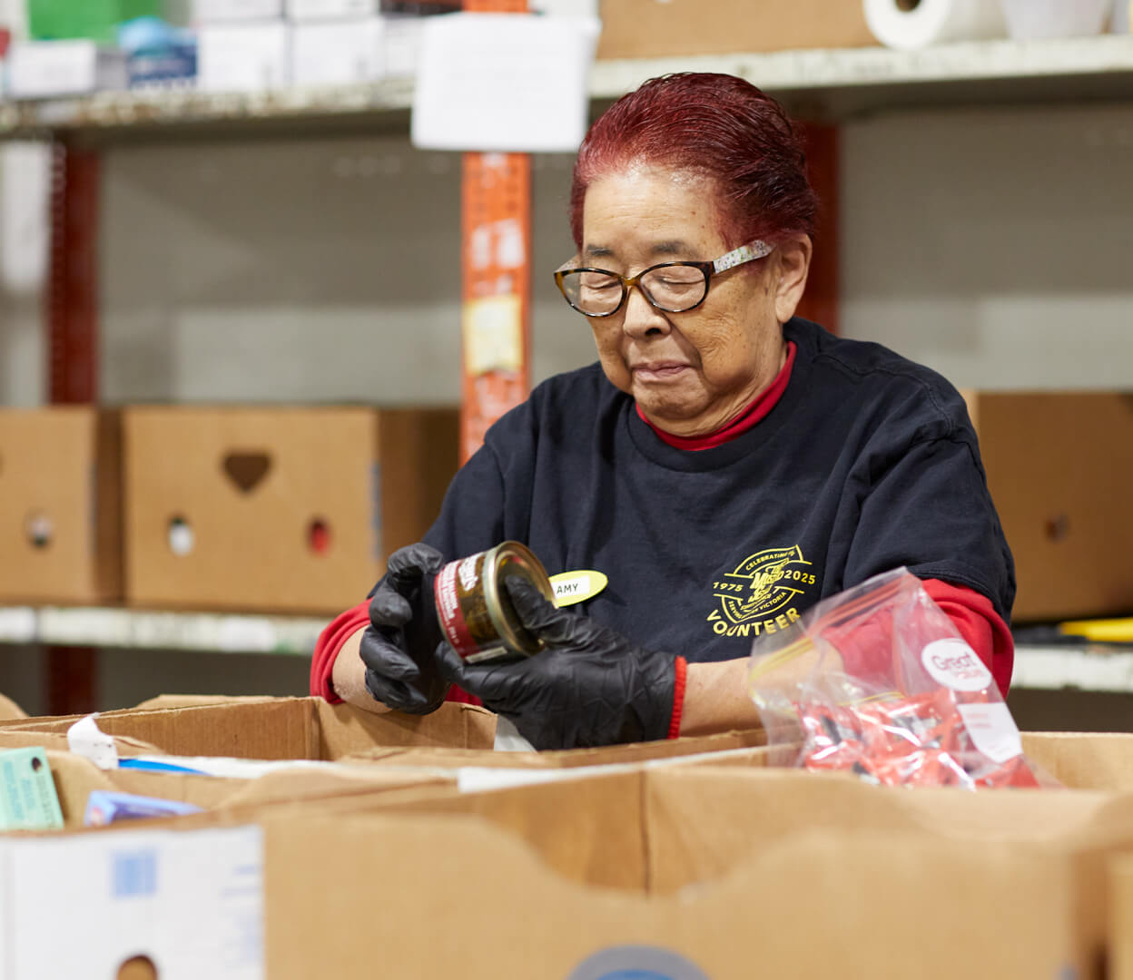 A woman sort food donations at the Mustard Seed Food Security Distribution Centre.
