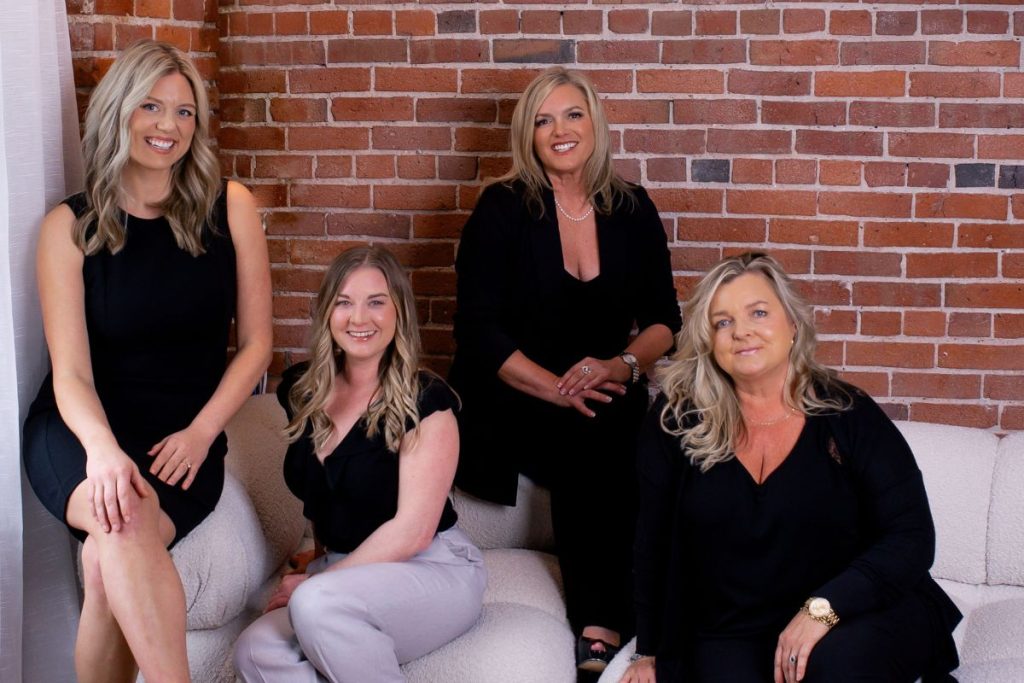 The Prosperity Planning team sit on a couch together.