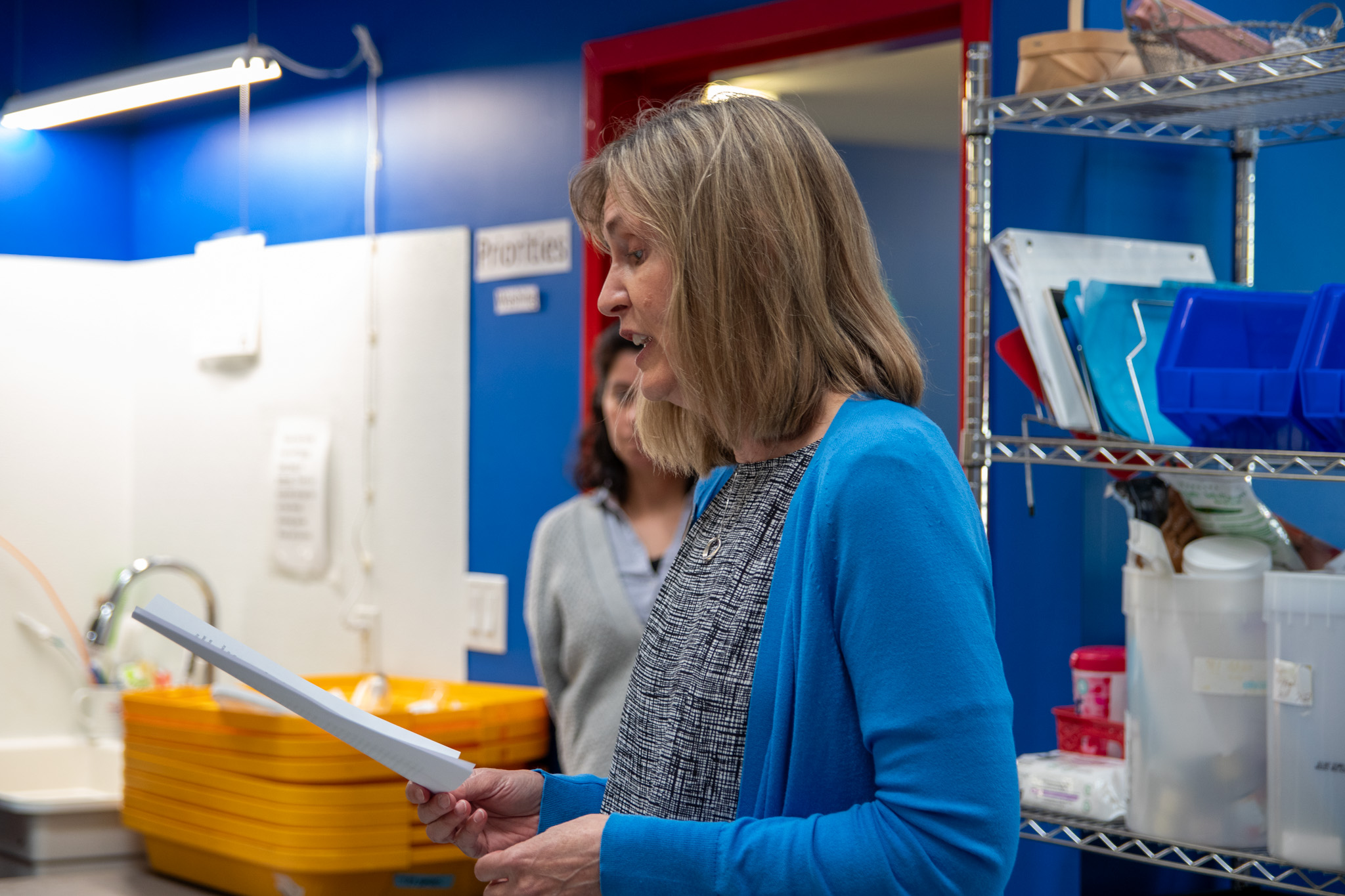 Carol Hall from the Victoria Foundation makes a speech at Soap For Hope's warehouse.
