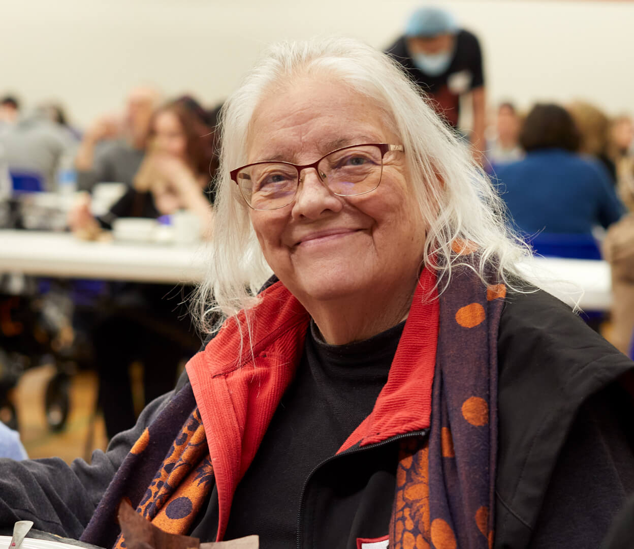 A woman smiles at the camera while attending an event at the Victoria Native Friendship Centre.