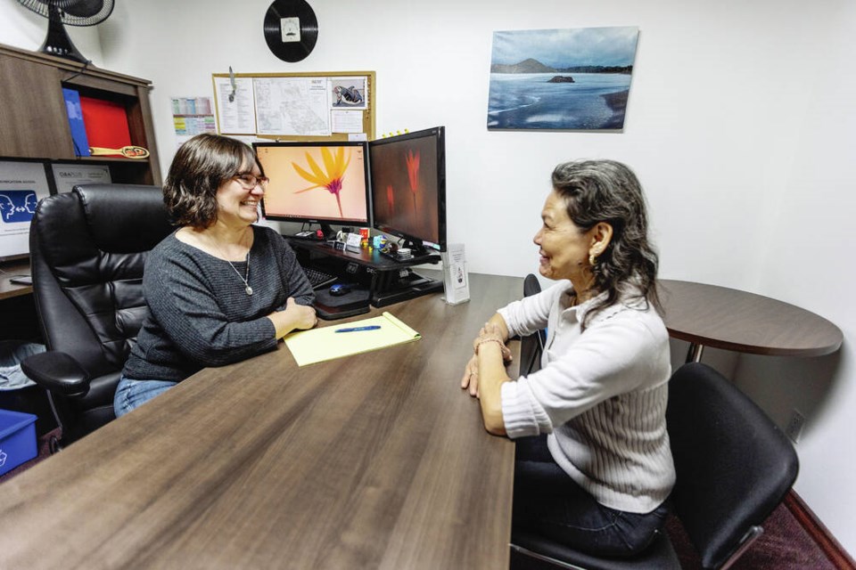 Paisley Pelletier, left, a case manager for the B.C. Aboriginal Network on Disability Society, works with client Sharon Borg
