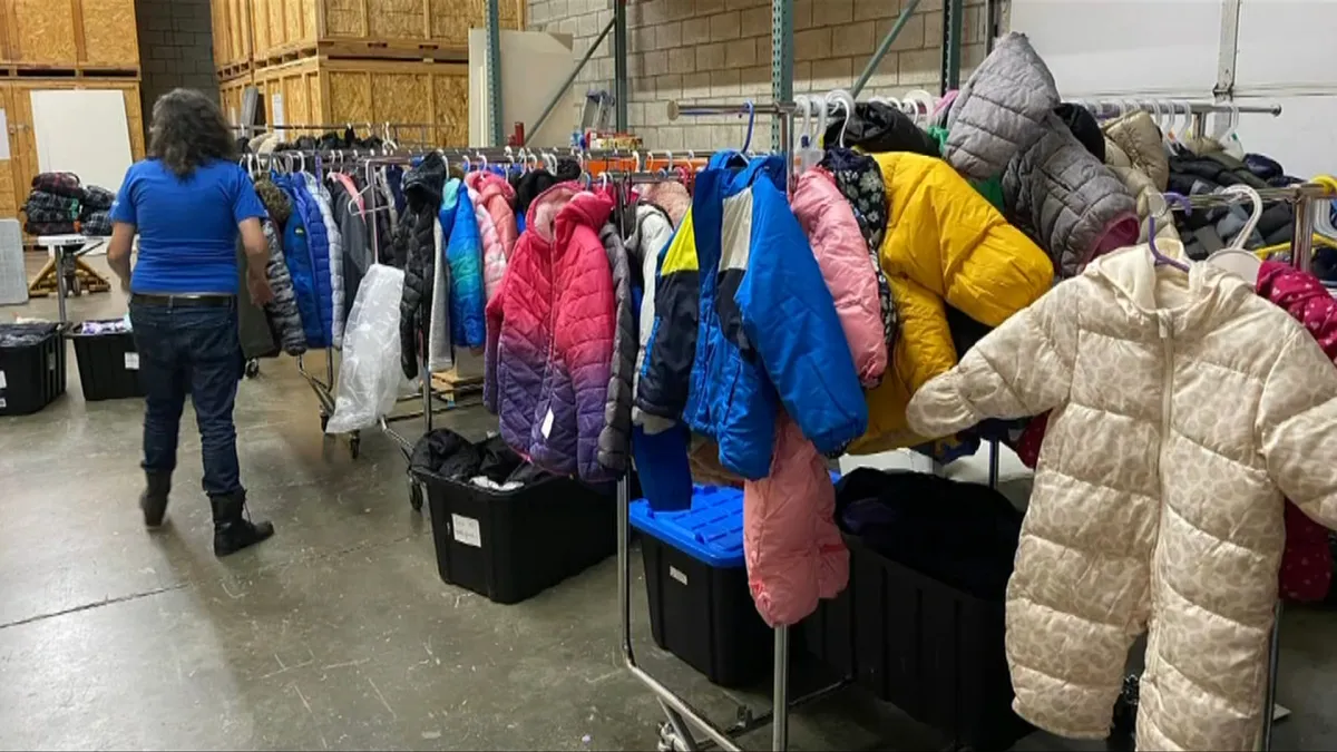 Coats on racks in the Coats for Kids Association warehouse.