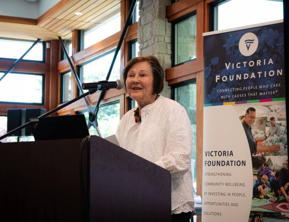 Sandra Richardson speaks at a podium in front of a Victoria Foundation banner.