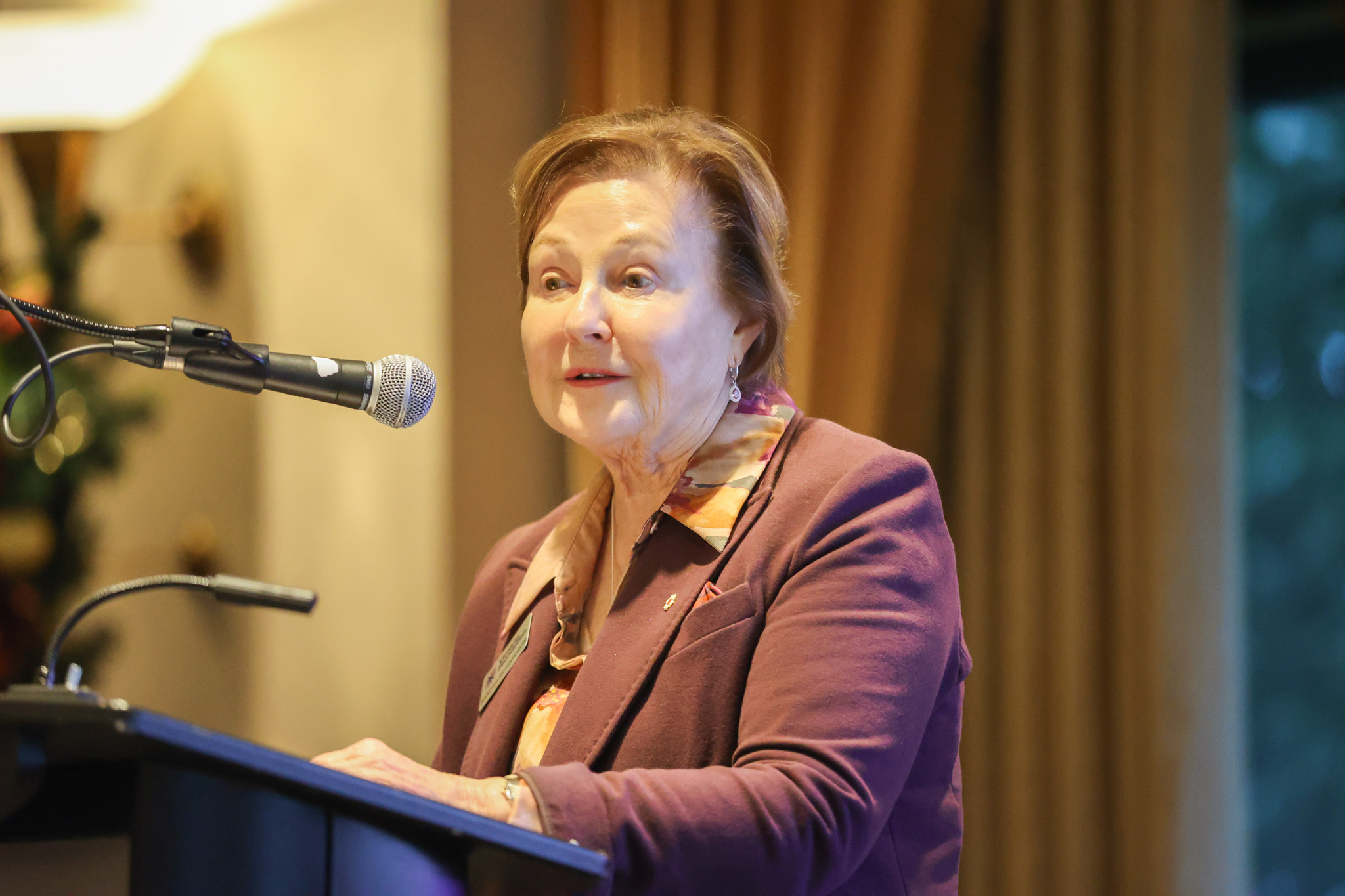 Sandra Richardson stands at a podium.