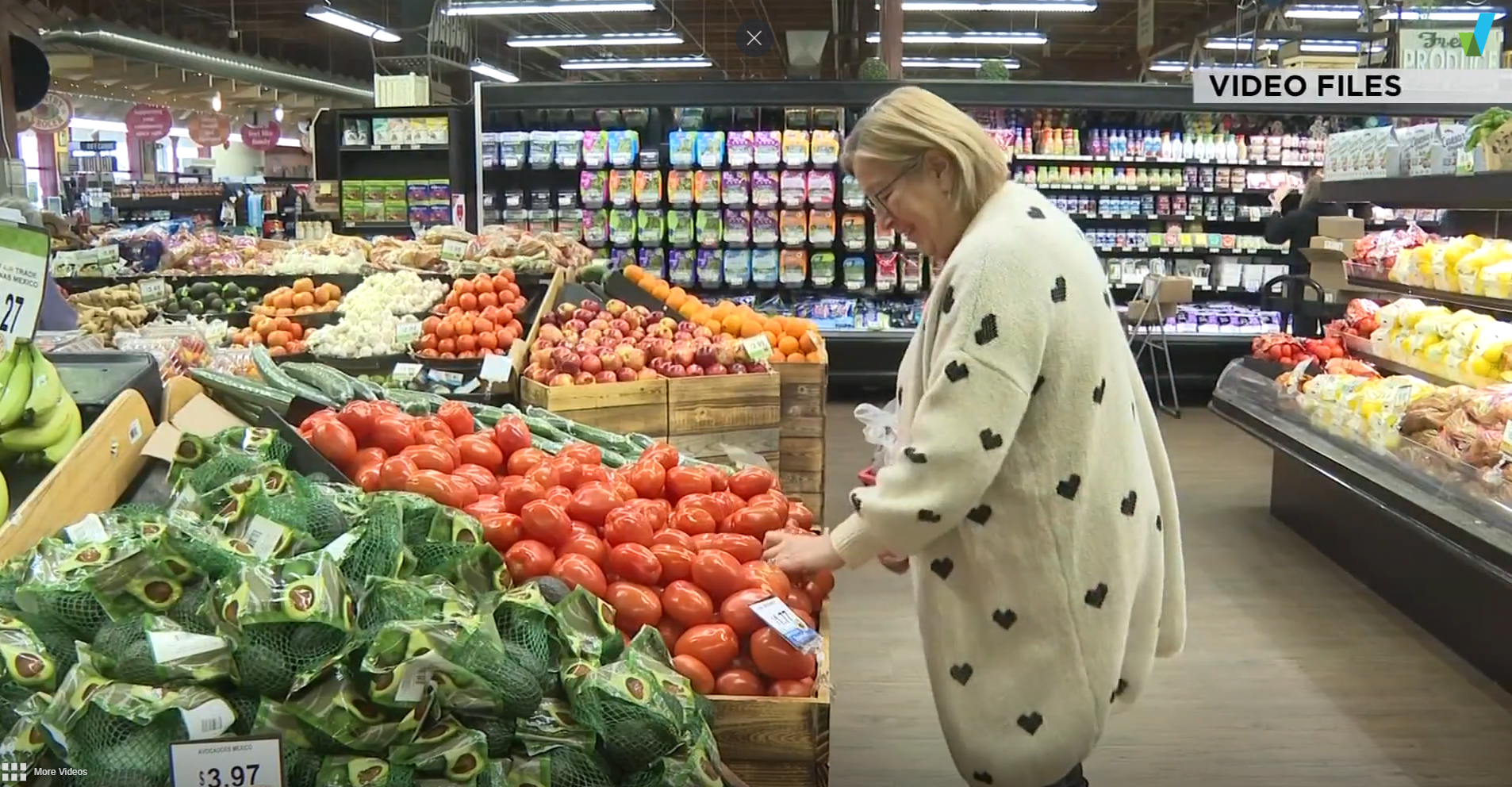 Shoppers browse produce at the grocery store. Food security.