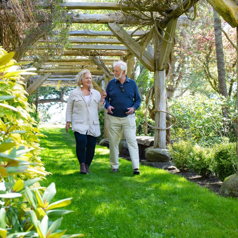 Susan Bloom walks in her garden with her professional advisor.