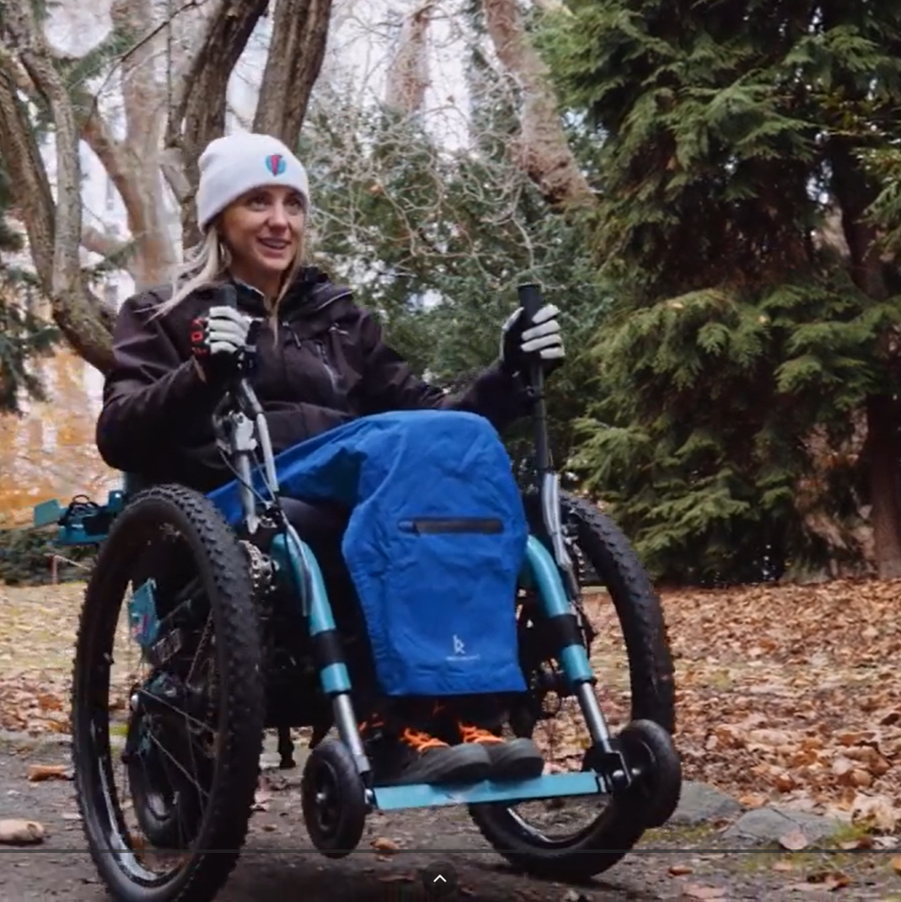 RAD society screenshot - Edited Tanelle Bolt from the RAD Society rides through the forest in her wheelchair.