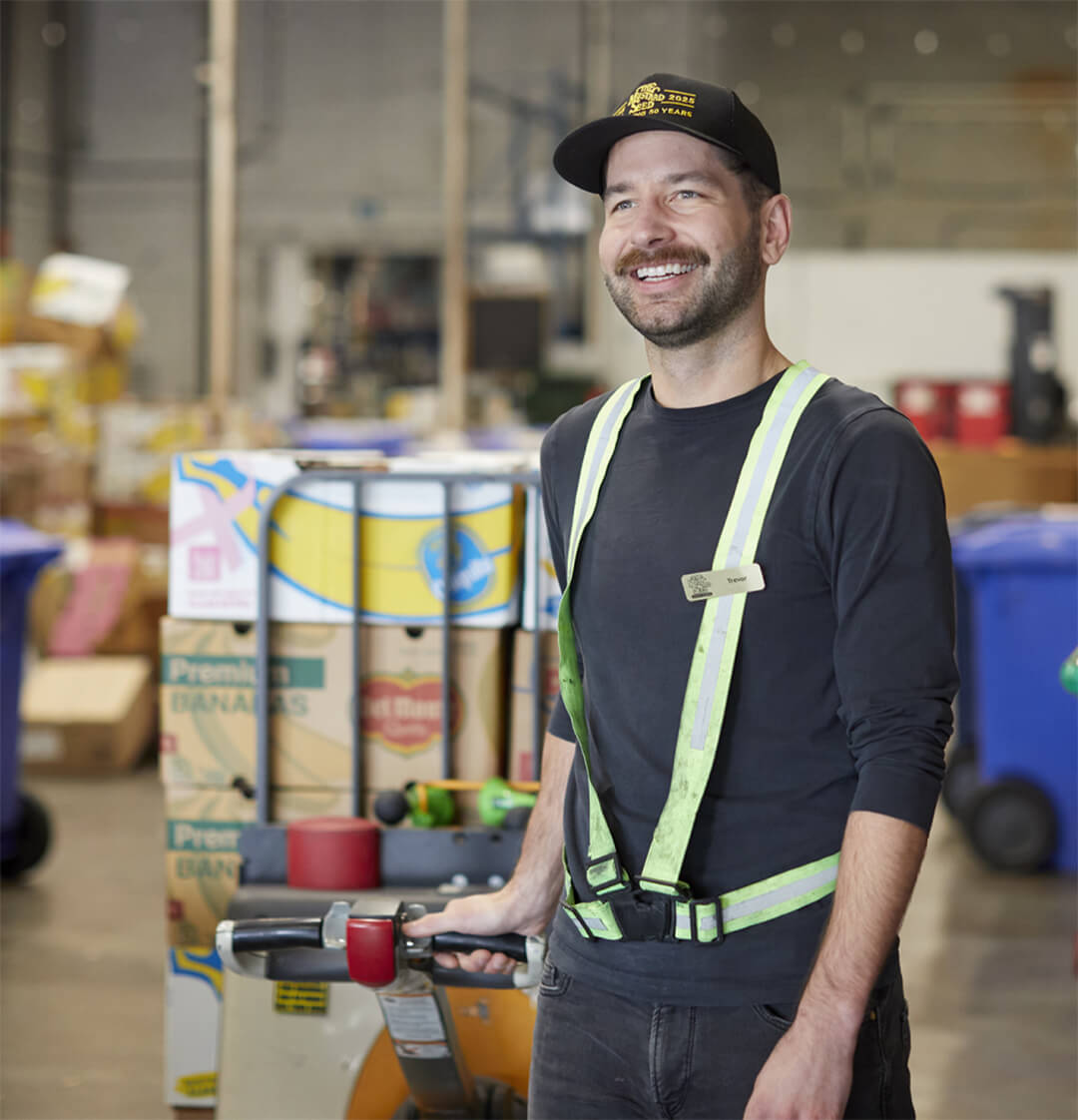 Worker moving a palette of food in a warehouse