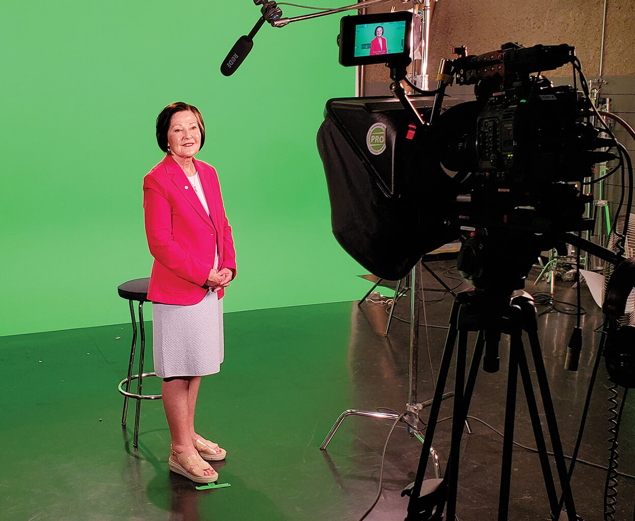 Sandra Richardson speaking in a studio in front of a green screen