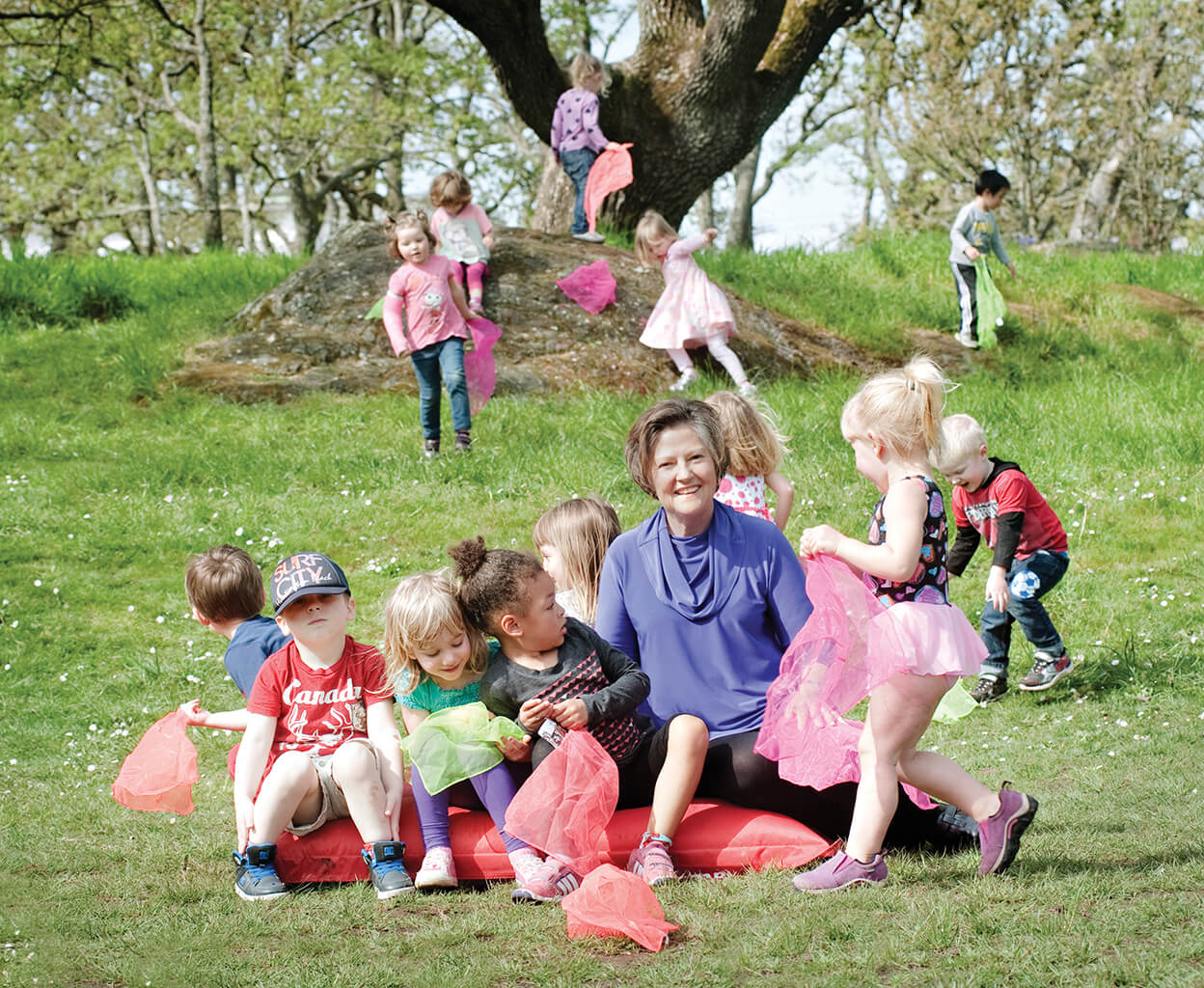 Sandra Richardson with a group of children playing outside