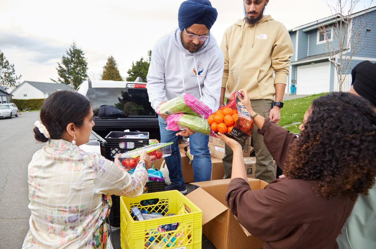 Members of the Fateh Care Charity load a truck up with charitable food.